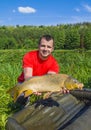 Fisherman with carp fish trophy Royalty Free Stock Photo