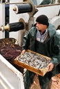 Fisherman carrying box with fish