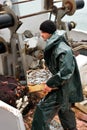 Fisherman carrying box with fish