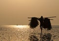 Fisherman carrying fishing net. Royalty Free Stock Photo