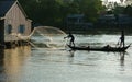 Fisherman cast a net on river