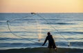 The fisherman cast a net the sea