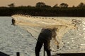 A fisherman casting a fishing net Royalty Free Stock Photo