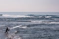 A fisherman casting his net from the beach Royalty Free Stock Photo