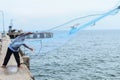 A fisherman casting his net from the boat Royalty Free Stock Photo