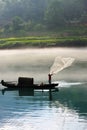 Fisherman casting net on river Royalty Free Stock Photo