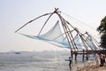 Fisherman casting nets in sea water at Kochi