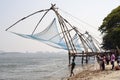 Fisherman casting nets in sea water at Kochi