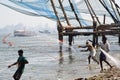 Fisherman casting nets in sea water at Kochi