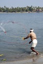 Fisherman casting nets in sea water at Kochi