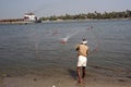 Fisherman casting nets in sea water at Kochi