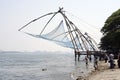 Fisherman casting nets in sea water at Kochi