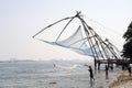 Fisherman casting nets in sea water at Kochi