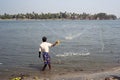 Fisherman casting nets in sea water at Kochi