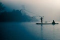 Fisherman casting out his fishing net early in the morning. Royalty Free Stock Photo