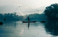 Fisherman casting out his fishing net in the river. Royalty Free Stock Photo