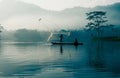 Fisherman casting out his fishing net in the river. Royalty Free Stock Photo