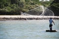 Fisherman casts his net