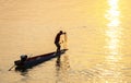 ``Fisherman casts his net from a small boat at sunset,on the Mekong river,in southern Laos Royalty Free Stock Photo