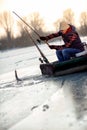 Fisherman catch fish - ice fishing on frozen lake Royalty Free Stock Photo