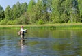 Fisherman catches of chub fly fishing in the Chusovaya river Royalty Free Stock Photo