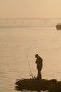 A Fisherman catches fish on the Dnieper River early in the morni Royalty Free Stock Photo