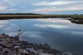 Fisherman catches fish on the evening lake.