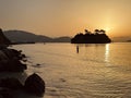 Fisherman catches fish in the sea against the backgro und of the Greek islands. Greek island with wooden bridge. Cameo island in Royalty Free Stock Photo