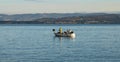 a fisherman catches fish on a small fishing boat