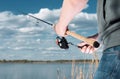 A fisherman catches a fish on spinning. Hands and coil closeup Royalty Free Stock Photo