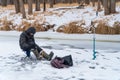 Fisherman catches a fish on winter fishing Royalty Free Stock Photo