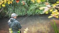 A fisherman catches spinning in the waders. Trout fishing