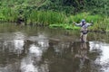 Fisherman catches tenkara on a beautiful forest creek