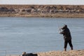 Fisherman catching a fish on a fishing tackle in the river