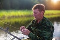 Fisherman catching fish on the lake from boat. Nature. Royalty Free Stock Photo