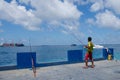 Fisherman catching fish using three rods