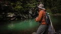 Fisherman catching trout on a river.