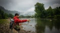 Fisherman catching trout on a river. Royalty Free Stock Photo