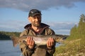 Fisherman caught a big salmon.