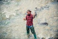 Fisherman caught a fish. Excited amazed fisher man in water catching trout fish, top view. Man fishing on river. Royalty Free Stock Photo