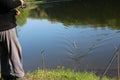 A fisherman caught a fish and hauls it ashore