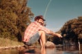 Fisherman caught a fish. Man fishing on river. Catching trout fish. Royalty Free Stock Photo