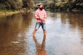 Fisherman caught a fish. Man fishing on river. Mature man fishing. Fisherman throws a spinning from shoreside. Positive Royalty Free Stock Photo