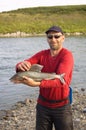 Fisherman caught a large grayling. Royalty Free Stock Photo