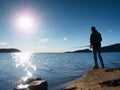 Fisherman check fishing line and pushing bait on the rod, prepare himself and throw lure far into peaceful water. Royalty Free Stock Photo