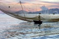 Fisherman checks his nets in early morning on river in Hoian, Vietnam Royalty Free Stock Photo