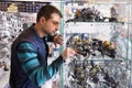 Fisherman choosing new baitcasting reel in shop Royalty Free Stock Photo