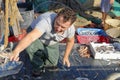 Fisherman cleaning the deck of a trawler boat. waste hard work Royalty Free Stock Photo