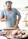 Fisherman cleaning his fish