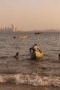 A fisherman climbing on his boat and pushing it to sea Royalty Free Stock Photo